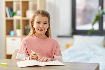 Image showing girl with notebook and marker drawing at home