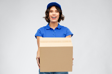 Image showing happy delivery girl with parcel box in blue