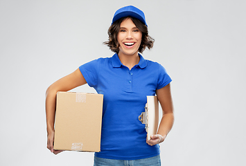 Image showing happy delivery girl with parcel box and clipboard