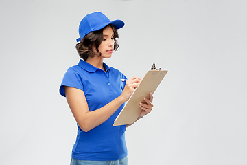Image showing delivery girl with clipboard and pen writing