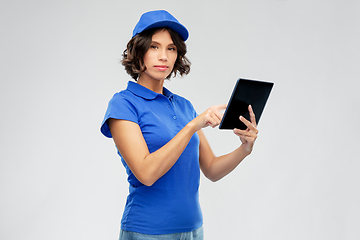 Image showing delivery girl in blue uniform with tablet computer