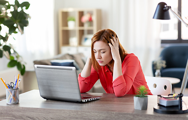 Image showing stressed woman with laptop working at home office