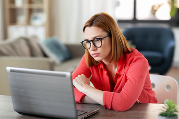 Image showing bored woman with laptop working at home office