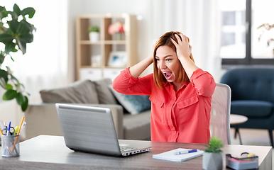 Image showing angry woman with laptop working at home office