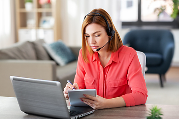 Image showing woman with headset and laptop working at home