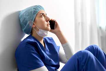 Image showing sad doctor or nurse calling on smartphone