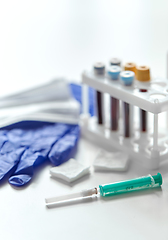Image showing syringe, beakers with blood test, gloves and mask