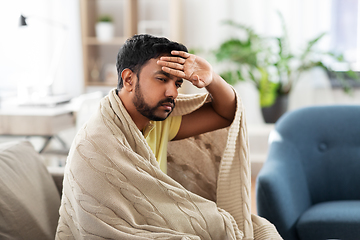 Image showing sick young man in blanket having headache or fever