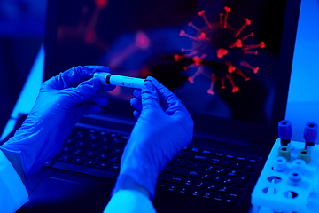 Image showing hand holding beaker with coronavirus blood test