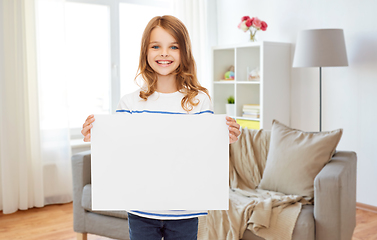 Image showing happy girl holding white blank paper sheet at home