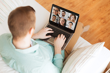 Image showing man with laptop having video call with colleagues