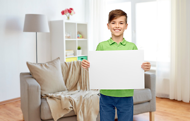 Image showing happy boy holding white blank paper sheet at home