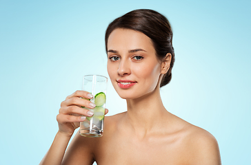 Image showing woman drinking water with cucumber and ice