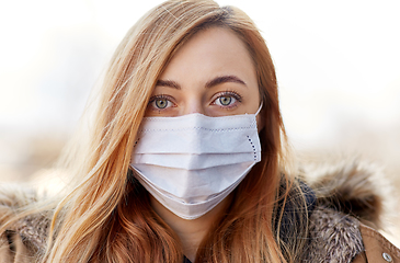 Image showing young woman wearing protective medical mask