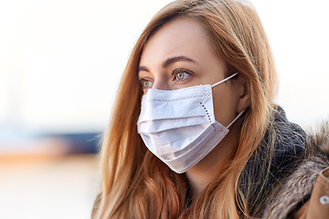 Image showing young woman wearing protective medical mask