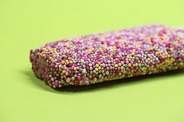 Image showing Ice cream on stick with colorful sprinkles