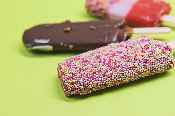 Image showing Set of ice cream on stick with colorful sprinkles