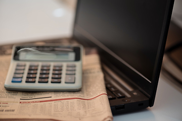 Image showing Black notebook, calculator and finance newspaper. Coronavirus concept. Work from home concept