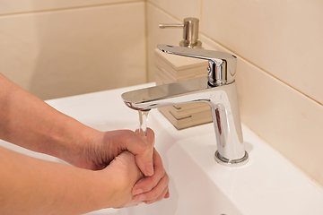 Image showing Washing of hands with soap under running water