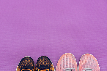 Image showing Sneakers and a purple fitness mat. Sport concept