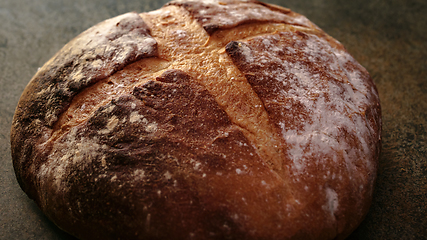 Image showing Freshly baked natural bread is on the kitchen table.