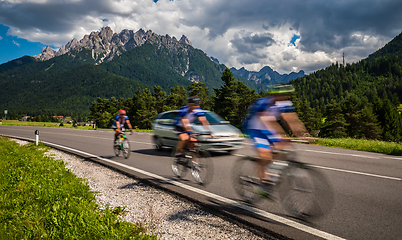 Image showing Cyclists riding a bicycle on the road in the background the Dolo