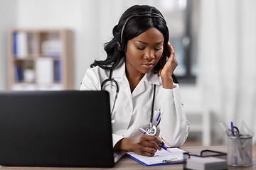 Image showing doctor with headset and clipboard at hospital