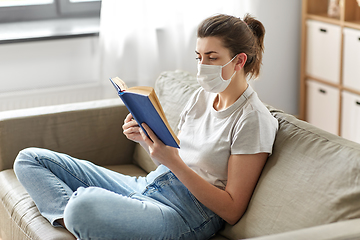 Image showing sick woman in medical mask reading book at home