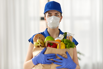 Image showing delivery woman in face mask with food in paper bag