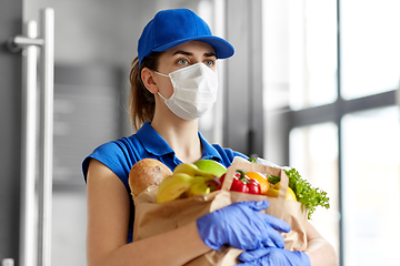 Image showing delivery woman in face mask with food in paper bag