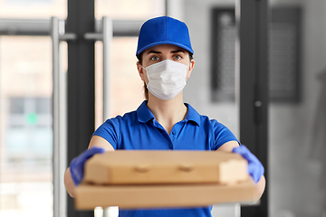 Image showing delivery woman in face mask with pizza boxes