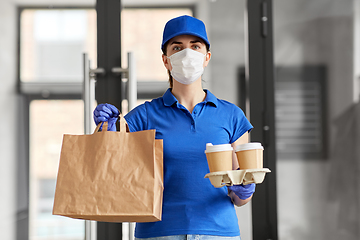 Image showing delivery woman in face mask with food and drinks