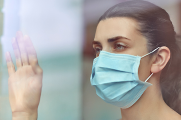 Image showing sick young woman wearing protective medical mask