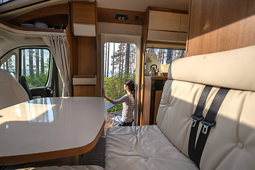 Image showing Woman in the interior of a camper RV motorhome with a cup of cof