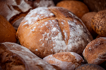 Image showing Freshly baked natural bread is on the kitchen table.