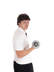 Image showing Young man standing in profile lifting dumbbell
