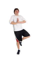 Image showing Man standing on one leg doing yoga