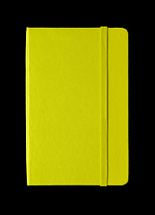 Image showing Lime green closed notebook isolated on black