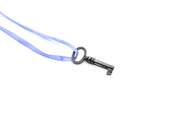 Image showing Vintage silver key on blue ribbon on white background