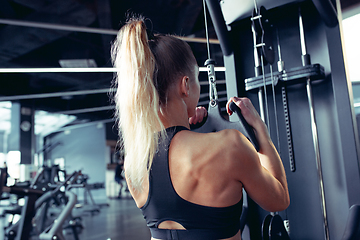 Image showing The female athlete training hard in the gym. Fitness and healthy life concept.