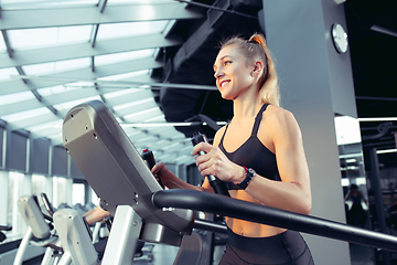 Image showing The female athlete training hard in the gym. Fitness and healthy life concept.