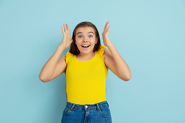 Image showing Caucasian teen girl portrait isolated on blue studio background