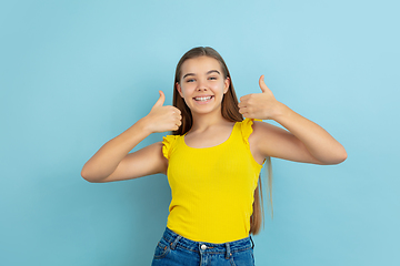 Image showing Caucasian teen girl portrait isolated on blue studio background