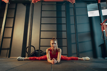 Image showing The female athlete training hard in the gym. Fitness and healthy life concept.