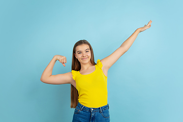 Image showing Caucasian teen girl portrait isolated on blue studio background