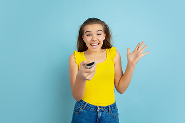 Image showing Caucasian teen girl portrait isolated on blue studio background