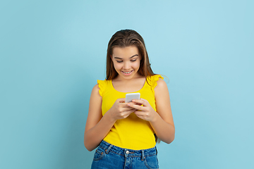 Image showing Caucasian teen girl portrait isolated on blue studio background