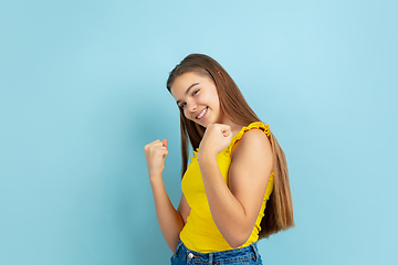 Image showing Caucasian teen girl portrait isolated on blue studio background