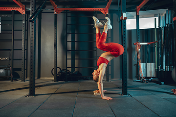 Image showing The female athlete training hard in the gym. Fitness and healthy life concept.