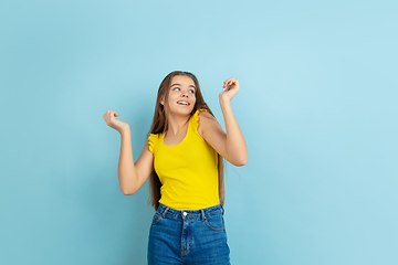 Image showing Caucasian teen girl portrait isolated on blue studio background